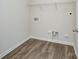 Empty laundry room with hardwood floors and washer/dryer hookups, ready for customization at 427 Carolina Hemlock Dr, Locust, NC 28097