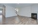 An empty living room with hardwood floors, a staircase, and a fireplace, ready to be customized at 427 Carolina Hemlock Dr, Locust, NC 28097
