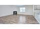 Open living area with fireplace, large window, and adjacent kitchen bar area at 427 Carolina Hemlock Dr, Locust, NC 28097