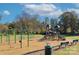 Community playground with swings, slides, benches, and a green space for outdoor fun at 427 Carolina Hemlock Dr, Locust, NC 28097
