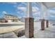 View from the covered front porch showing brick columns and white railings at 427 Carolina Hemlock Dr, Locust, NC 28097
