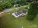 An aerial view showing the back of the house, lawn and deck at 5129 Whitetail Ct, Crouse, NC 28033