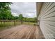 View of the home's wood back deck, overlooking the lawn and wooded area at 5129 Whitetail Ct, Crouse, NC 28033