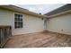 View of the home's wood back deck, with vinyl siding, a window and a door at 5129 Whitetail Ct, Crouse, NC 28033