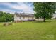 The home's large back yard features mature trees, a fire pit and a wood deck at 5129 Whitetail Ct, Crouse, NC 28033