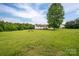 The home's large back yard features mature trees, a fire pit and a wood deck at 5129 Whitetail Ct, Crouse, NC 28033