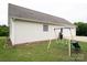 Home's backyard featuring a swing set, white siding, and a two-car garage at 5129 Whitetail Ct, Crouse, NC 28033