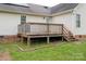 Backyard view of a white vinyl sided home featuring a wooden deck with railings and yard at 5129 Whitetail Ct, Crouse, NC 28033