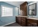 Bathroom featuring dual vanities, a linen closet, and neutral countertops at 5129 Whitetail Ct, Crouse, NC 28033