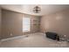 This cozy bedroom features neutral walls, carpet flooring, two shelves, and a decorative ceiling fan at 5129 Whitetail Ct, Crouse, NC 28033