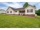 Charming single-Gathering home featuring vinyl siding, red brick foundation, and a well-maintained front lawn at 5129 Whitetail Ct, Crouse, NC 28033