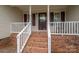 Inviting front porch with brick steps, white railings, and a covered entryway offering curb appeal at 5129 Whitetail Ct, Crouse, NC 28033
