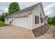 Spacious two-car garage with white doors and an American flag in the front yard at 5129 Whitetail Ct, Crouse, NC 28033
