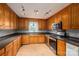 Well-maintained kitchen with oak cabinets, stone countertops, and stainless steel appliances at 5129 Whitetail Ct, Crouse, NC 28033