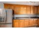 This kitchen features wood cabinets and stainless steel refrigerator at 5129 Whitetail Ct, Crouse, NC 28033