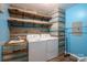 Laundry room featuring custom cabinets, shelving, and a utility sink at 5129 Whitetail Ct, Crouse, NC 28033