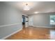 A light-filled living room boasts hardwood floors, neutral paint, and stylish lighting at 5129 Whitetail Ct, Crouse, NC 28033
