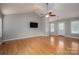 Open-concept living room with vaulted ceiling, hardwood floors, and natural light at 5129 Whitetail Ct, Crouse, NC 28033