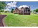 Brick home with an enclosed sunroom overlooking the large yard with mature trees at 5164 Mill Race Ln, Lancaster, SC 29720