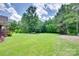 Expansive backyard with lush green grass and mature trees, creating a serene outdoor space at 5164 Mill Race Ln, Lancaster, SC 29720