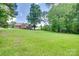Well-maintained lawn and mature trees surround the brick home, enhancing its curb appeal at 5164 Mill Race Ln, Lancaster, SC 29720