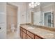 Bathroom with marble countertops, wood cabinets and a large, bright mirror at 5164 Mill Race Ln, Lancaster, SC 29720