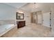 Open bathroom featuring a soaking tub, vanity with mirror, tile flooring, and glass-enclosed shower at 5164 Mill Race Ln, Lancaster, SC 29720