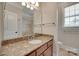 Bathroom with marble countertops and tiled shower at 5164 Mill Race Ln, Lancaster, SC 29720