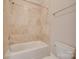 Tiled bathroom with a shower-tub combination and a white toilet at 5164 Mill Race Ln, Lancaster, SC 29720