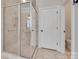 Modern bathroom featuring a glass-enclosed shower with tile surround and a white door to the toilet at 5164 Mill Race Ln, Lancaster, SC 29720