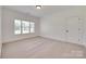 Neutral carpeted bedroom featuring white walls, trim, and a bright window at 5164 Mill Race Ln, Lancaster, SC 29720