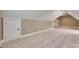 Finished bonus room with carpet, sloped ceilings, and door to storage at 5164 Mill Race Ln, Lancaster, SC 29720