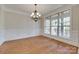 Bright dining room with hardwood floors, chandelier, and large window at 5164 Mill Race Ln, Lancaster, SC 29720