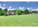 Well-manicured front yard with a lush lawn leading to a charming home with stone accents at 5164 Mill Race Ln, Lancaster, SC 29720