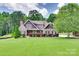 Charming two-story home with manicured lawn, mature trees, and stone accents at 5164 Mill Race Ln, Lancaster, SC 29720