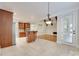 Open kitchen and living room layout with travertine floors and warm wood cabinets at 5164 Mill Race Ln, Lancaster, SC 29720