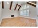 Open living room featuring vaulted ceilings, wooden beams, fireplace, and hardwood floors at 5164 Mill Race Ln, Lancaster, SC 29720