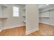 Spacious walk-in closet with hardwood floors, shelving, and a window for natural light at 5164 Mill Race Ln, Lancaster, SC 29720