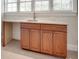 Wet bar featuring wood cabinetry, granite countertops, a sink, and a window for natural light at 5164 Mill Race Ln, Lancaster, SC 29720