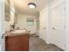 Bright bathroom with double sinks, wood-look floors, and ample storage at 5222 Sikes Mill Rd, Monroe, NC 28110