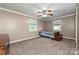 Neutral bedroom with carpet, fan, and natural light at 5222 Sikes Mill Rd, Monroe, NC 28110