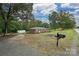 Charming brick home with a spacious front yard, mature trees, and a black mailbox at 5222 Sikes Mill Rd, Monroe, NC 28110