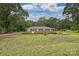 Charming brick home featuring a well-maintained lawn and landscaped front yard with mature trees at 5222 Sikes Mill Rd, Monroe, NC 28110