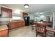 Kitchen with dark cabinets, stainless steel sink, and appliances with an open dining area at 5222 Sikes Mill Rd, Monroe, NC 28110