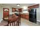 Functional kitchen showcasing dark cabinetry, black appliances, and a cozy dining area at 5222 Sikes Mill Rd, Monroe, NC 28110