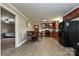 Kitchen and dining area with sleek black appliances, wood cabinets, and modern flooring at 5222 Sikes Mill Rd, Monroe, NC 28110