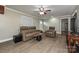 Charming living room featuring wood-look floors and comfortable leather furniture at 5222 Sikes Mill Rd, Monroe, NC 28110