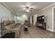 Inviting living room with cozy leather seating and wood-look floors at 5222 Sikes Mill Rd, Monroe, NC 28110