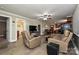 Cozy living room with wood-look floors and neutral paint, seamlessly connecting to the dining and kitchen areas at 5222 Sikes Mill Rd, Monroe, NC 28110