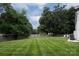 Expansive backyard with lawn, surrounding fence, and mature trees at 5741 Bentgrass Run Dr, Charlotte, NC 28269